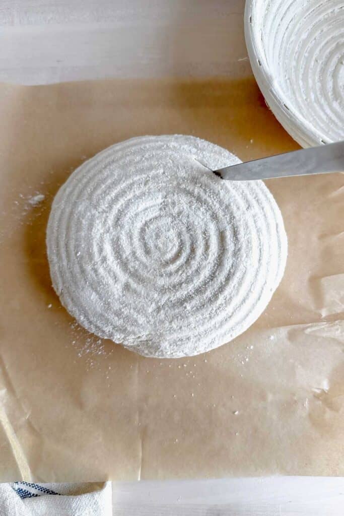 cutting a design into the top of the gluten free sourdough bread