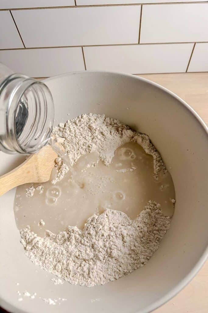 pouring water into dry ingredients