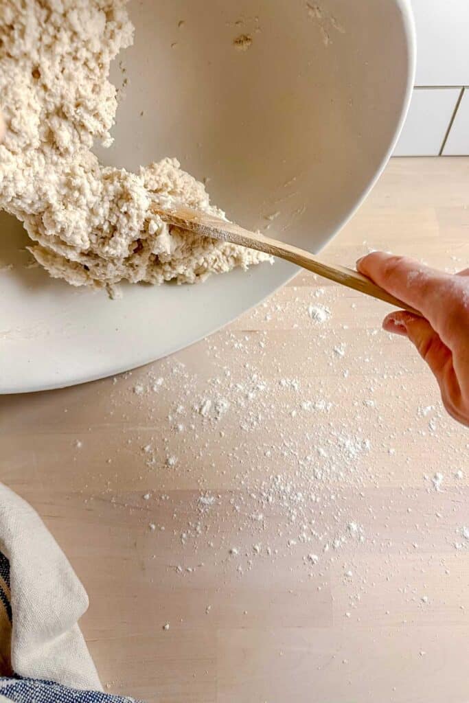 wooden spoon scooping out batter on to table top