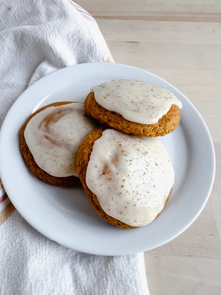 white plate with three pumpkin cookies