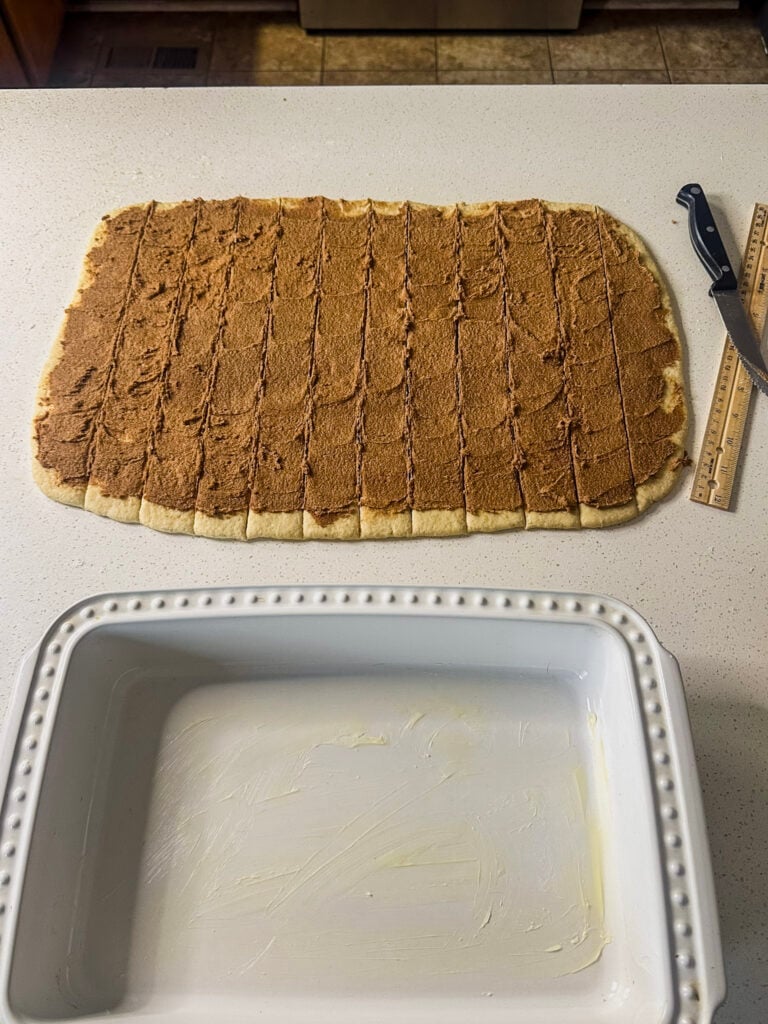 topped cinnamon roll dough sliced into sections 