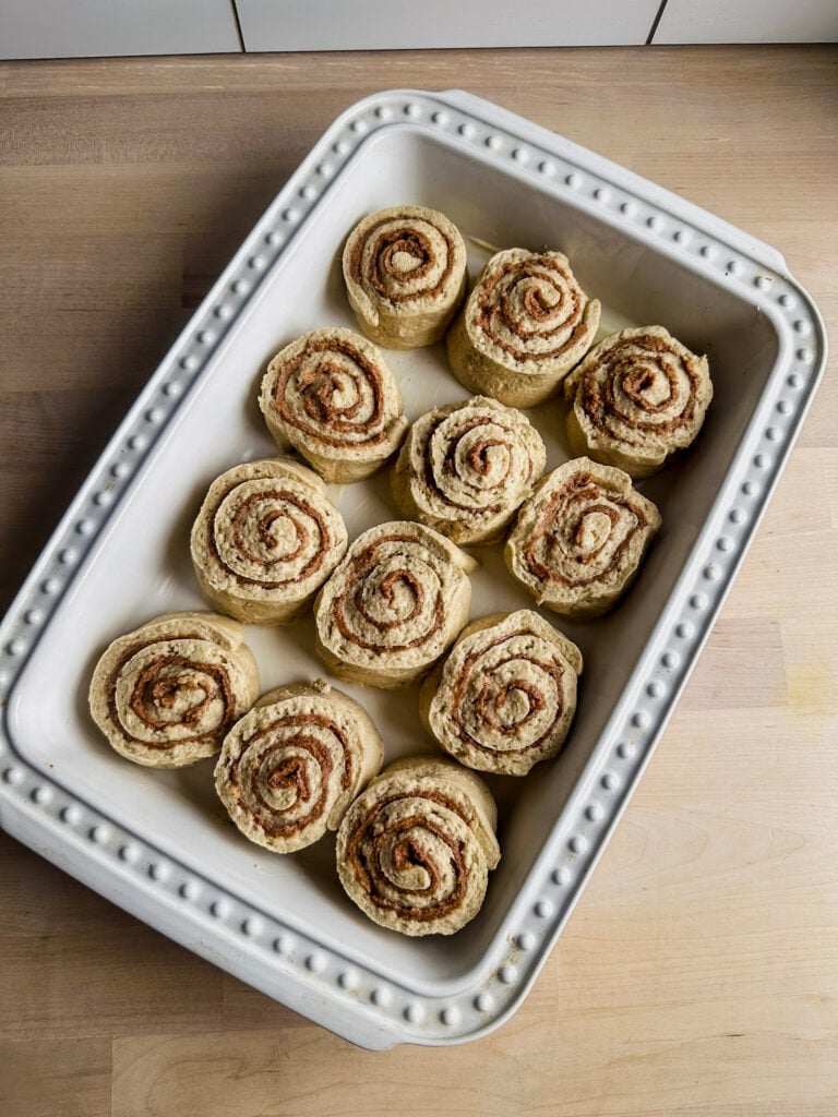 white pan with cinnamon rolls ready to be proofed