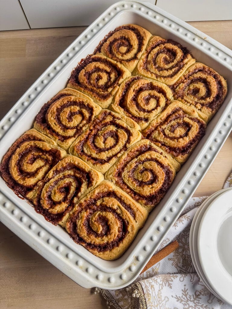 baked gluten free cinnamon rolls in white baking dish