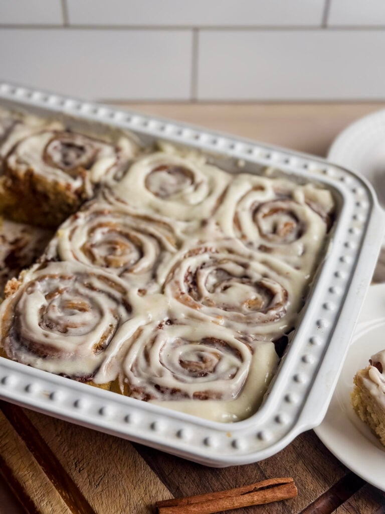 white baking dish with homemade sourdough cinnamon rolls that are gluten free