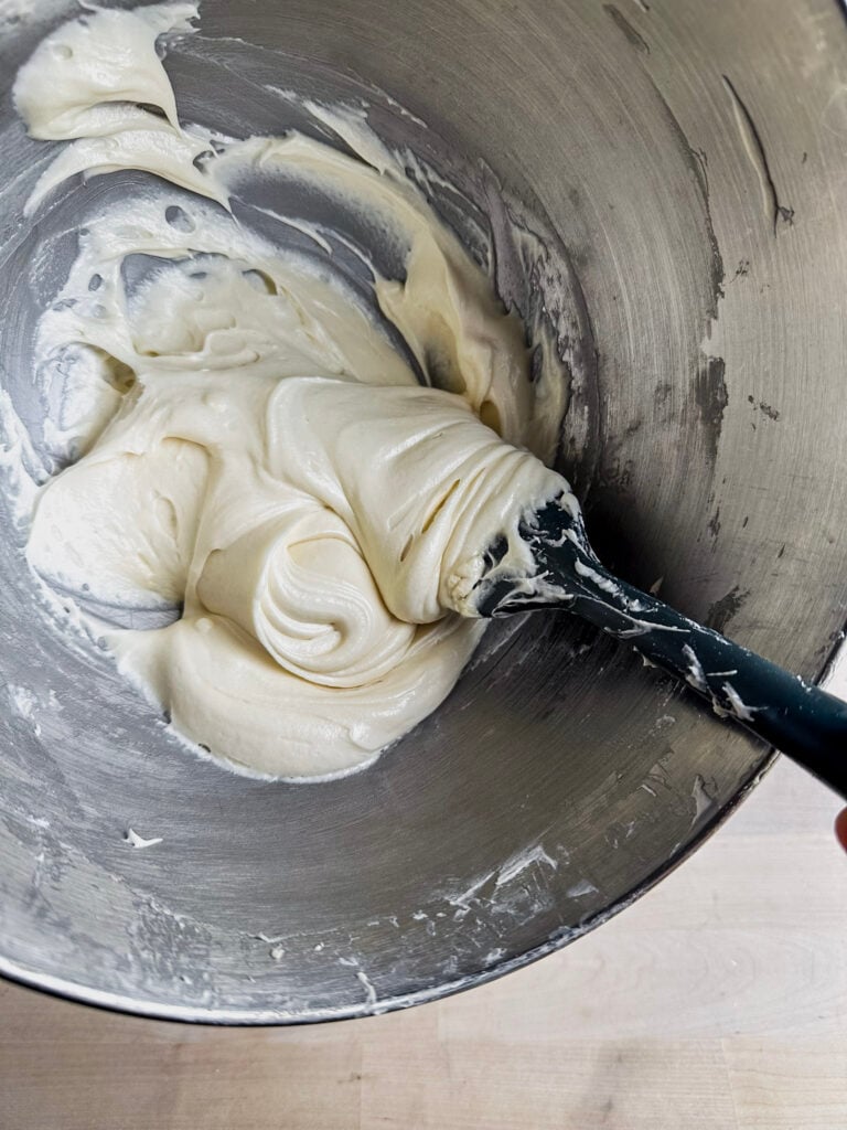 stand mixer bowl with fluffy cream cheese frosting