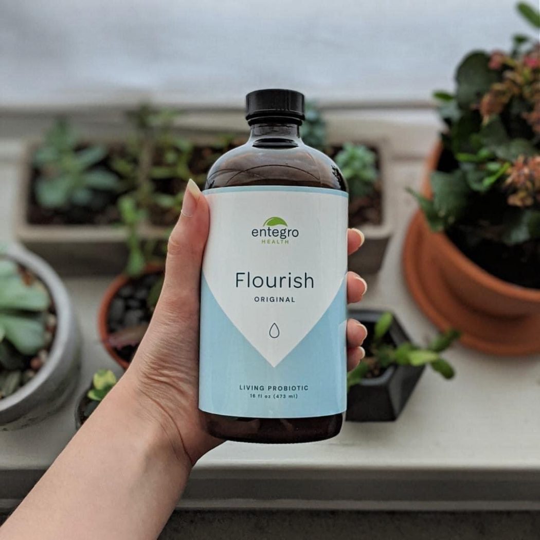 Bottle of Flourish over plants