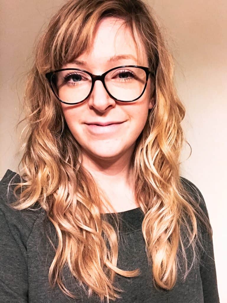 Woman wearing gray shirt with curly dried hair 