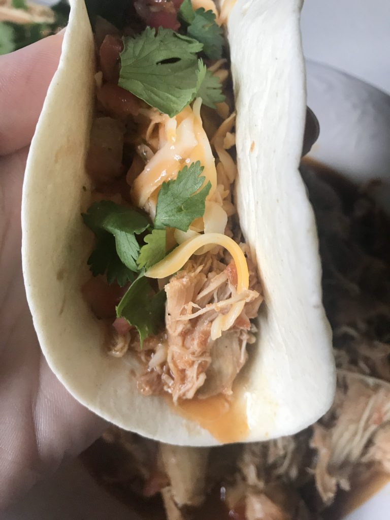 Taco with shredded chicken cheese cilantro