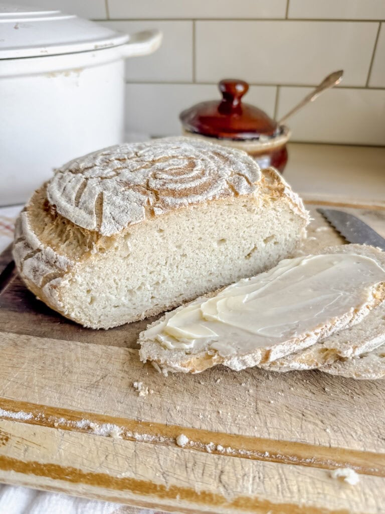 loaf of gluten free sourdough bread with butter on a slice