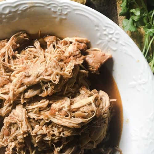 Instant Pot Taco Chicken shredded on wood cutting board