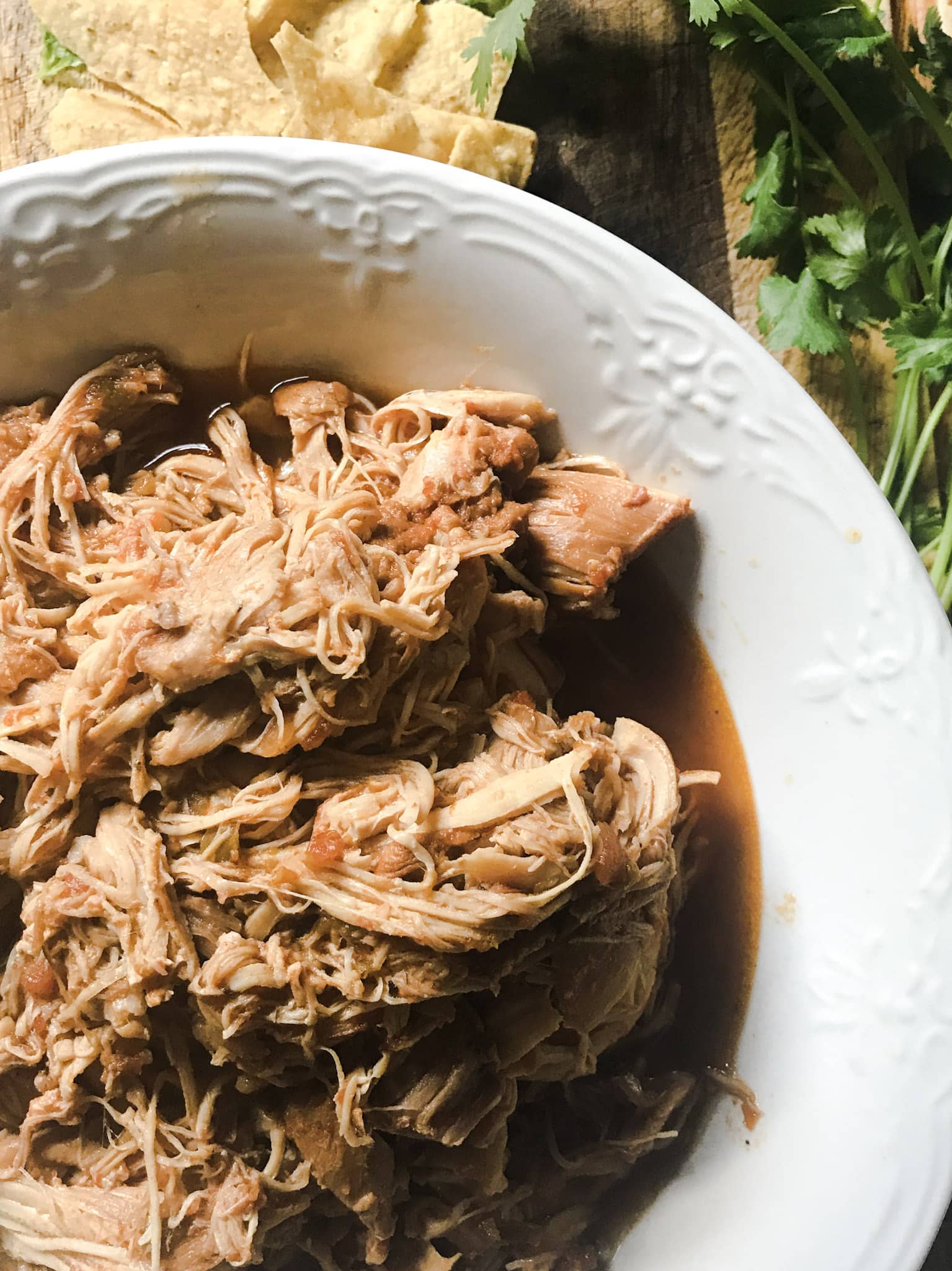 Instant Pot Taco Chicken shredded on wood cutting board