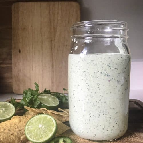 lime wedges jalepenos and cilantro sauce sitting on top of a cutting board