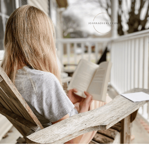 oldest daughter reads some of her schoolwork out on the front porch