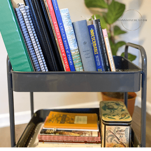 a gray cart holds morning time books and supplies