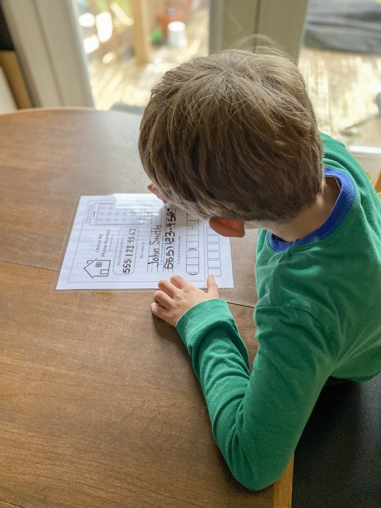 young boy filling out worksheet