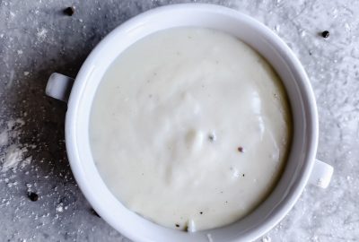 bowl of gluten free white sauce on gray counter