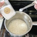 salt and pepper being added to the sauce