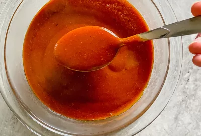 spoonful of gluten free enchilada sauce made at home with simple ingredients