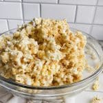 bowl of homemade caramel popcorn on white table