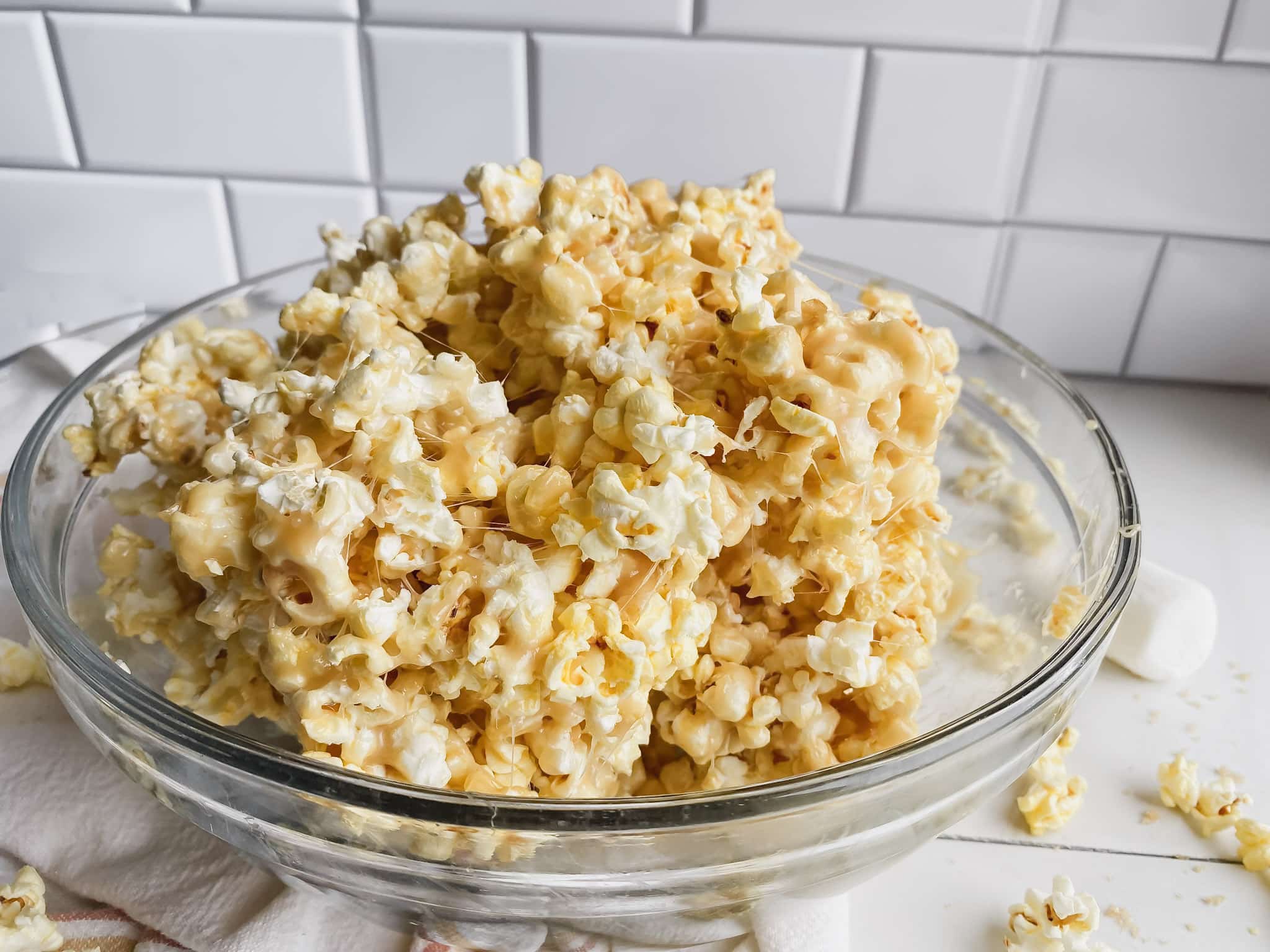 bowl of homemade caramel popcorn on white table