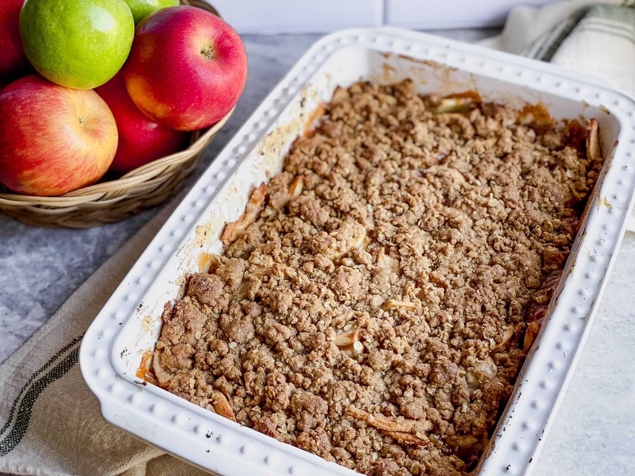 gluten free apple crisp with oats in a white 9x13 pan