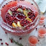large punch bowl with red Christmas punch with cranberry orange slice ice ring