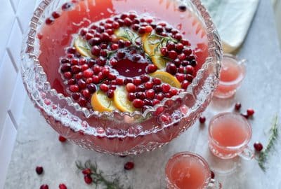 large punch bowl with red Christmas punch with cranberry orange slice ice ring