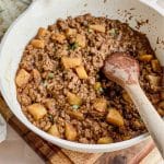 large skillet with ground meat and potatoes for Picadillo