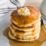 pile of gluten free pancakes on gray plate with fork