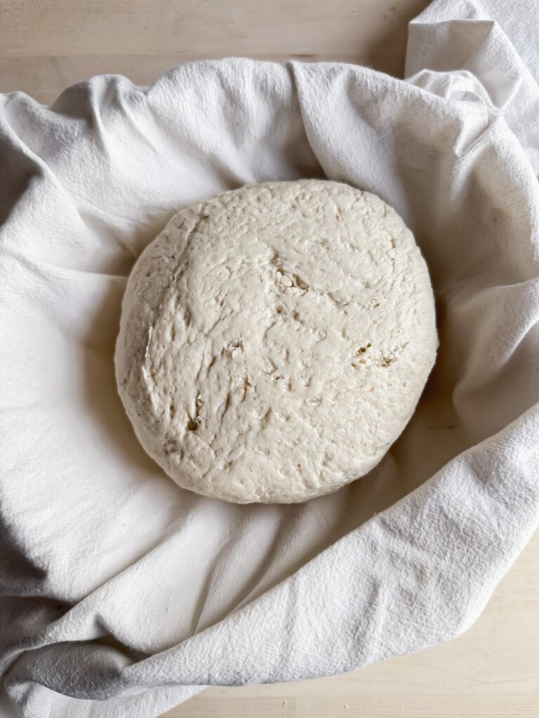 gluten free artisan bread loaf in a banneton basket