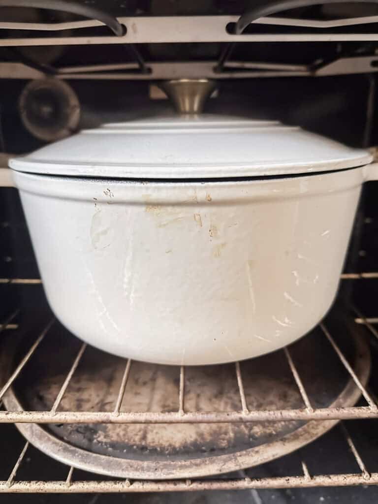 white Dutch oven in kitchen oven