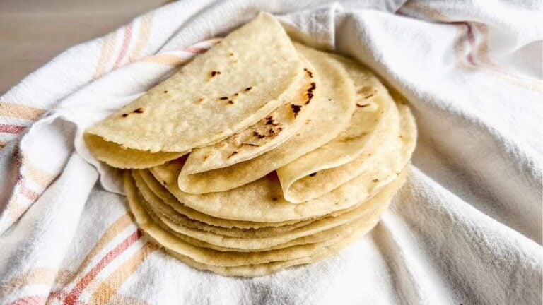pile of flexible gluten free tortillas on a tea towel