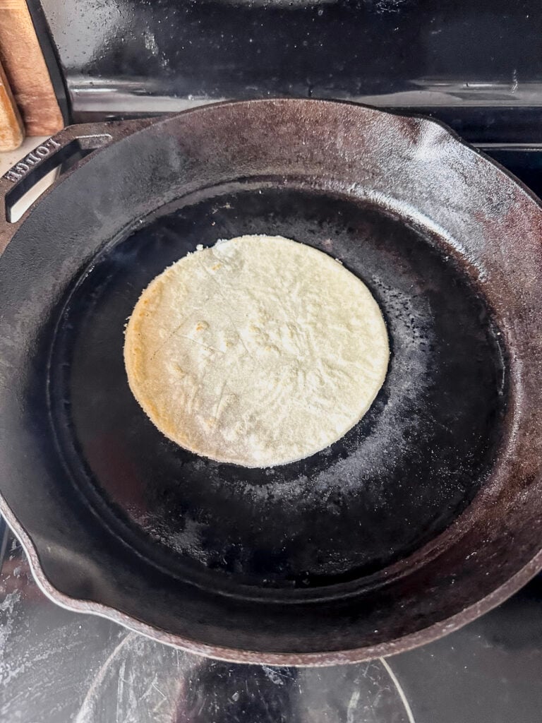 hot cast iron skillet with gluten free tortilla cooking