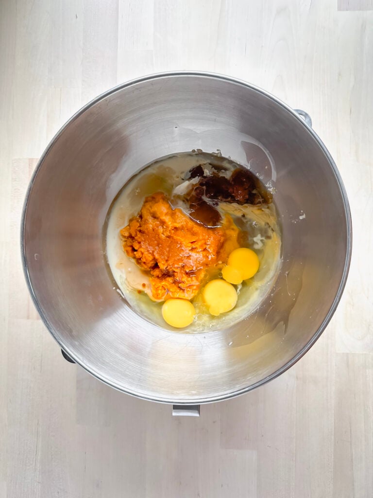 large metal mixing bowl with wet ingredients placed in it