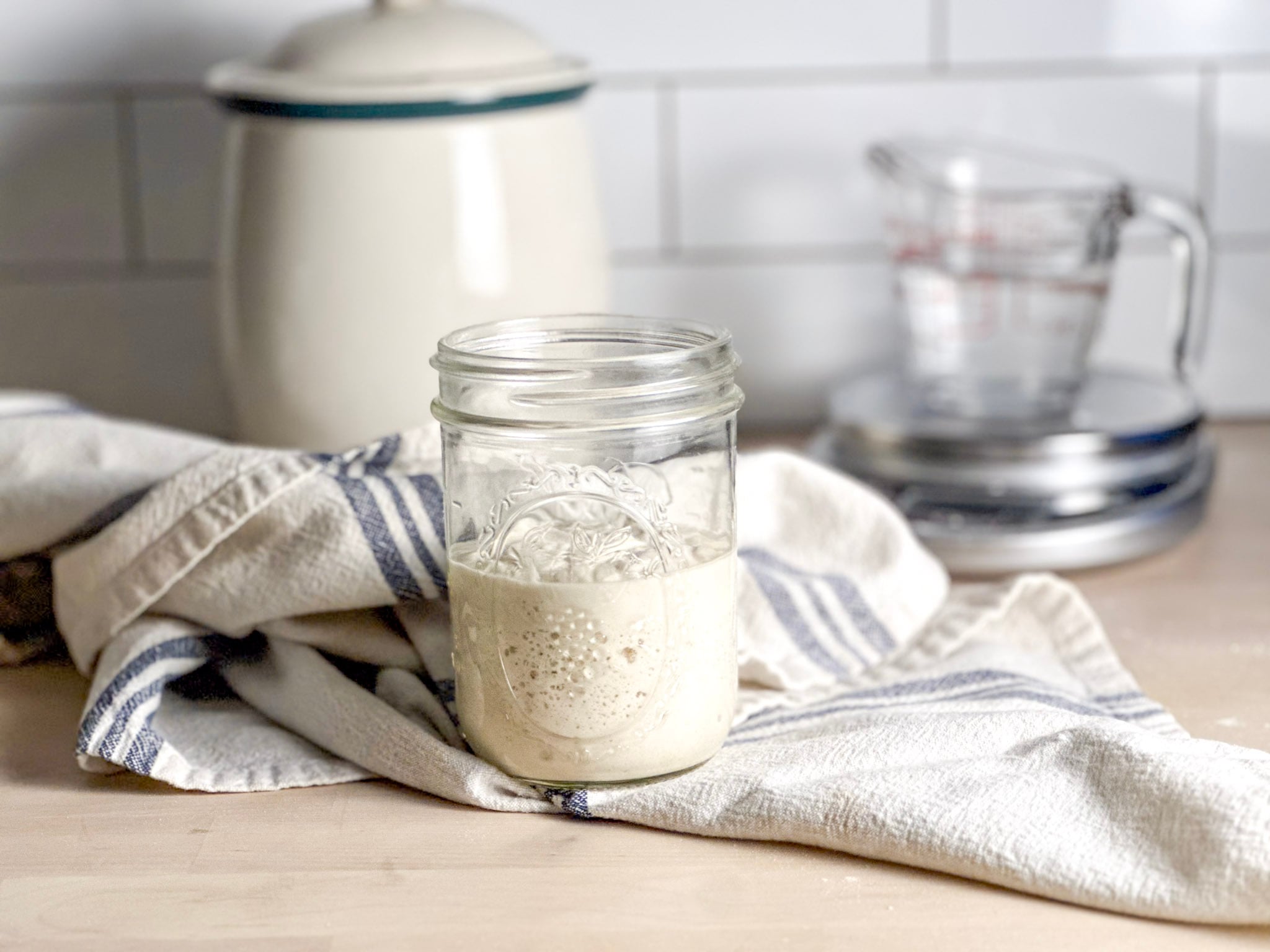 close up of a mason jar with gluten free sourdough rice flour starter