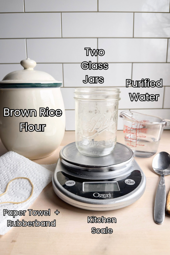 tools and ingredients to make gluten free sourdough starter sits on a wooden countertop