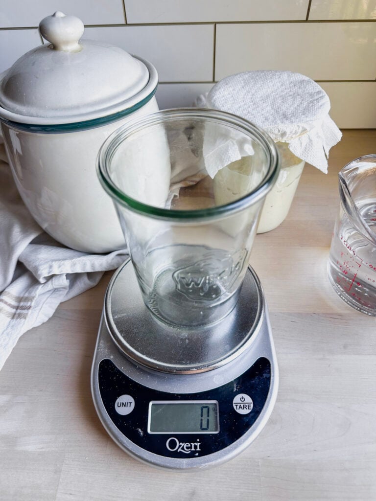 glass jar sitting on a kitchen scale