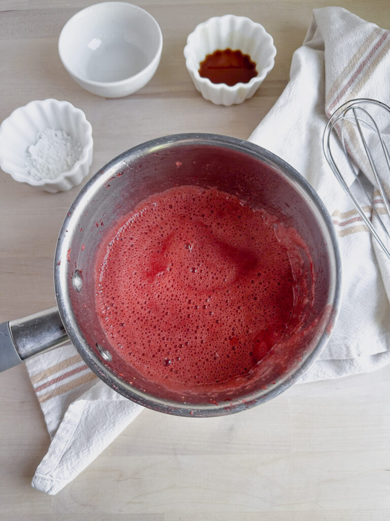 simmering strawberry jam on the stove top